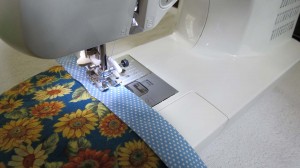 Stitching raw edge of binding to top of quilt
